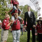 The world's tallest man Kosen poses with scouts in front of Vienna's Giant Wheel landmark