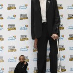 The world's tallest man Kosen poses with scouts in front of Vienna's Giant Wheel landmark